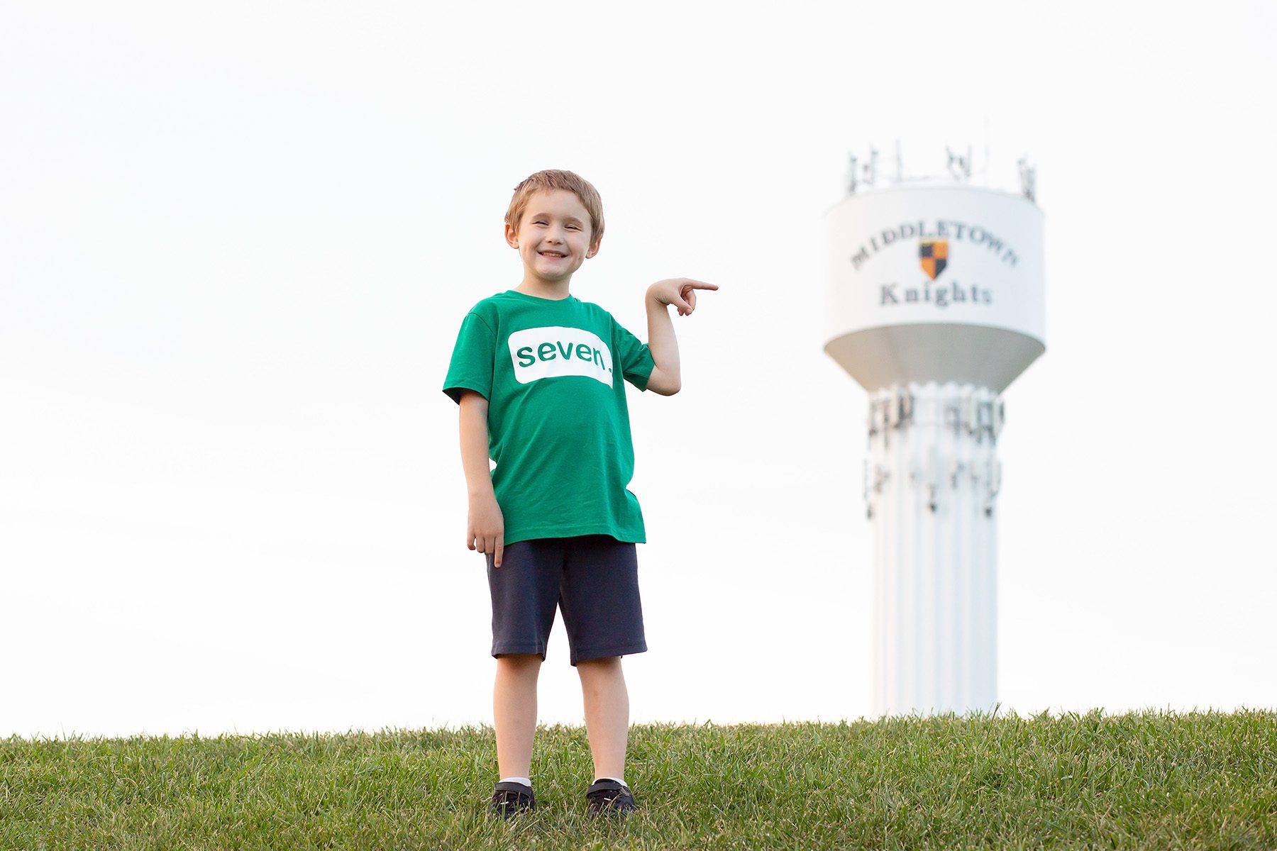 boy pointing to Middletown water tower